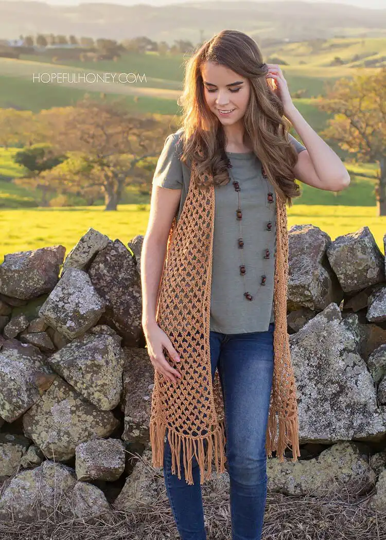 An airy Whispering Birch Bohemian Vest with open stitches, ideal for summer layering.