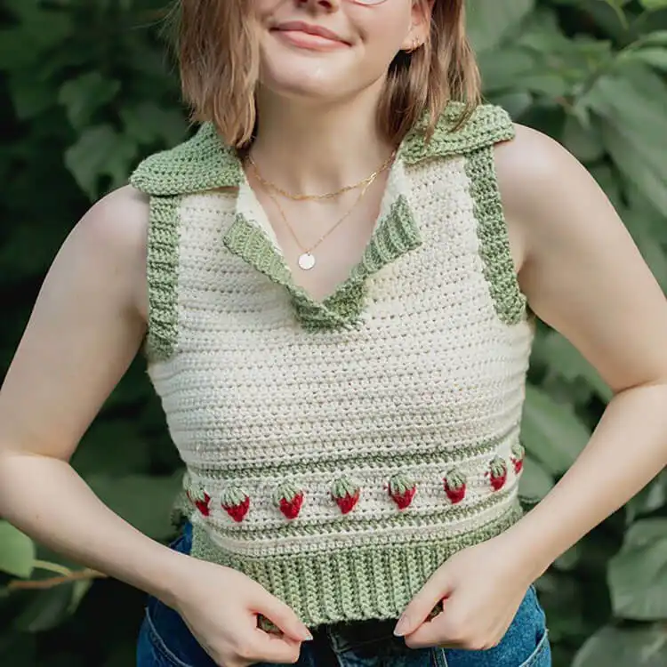 An adorable Everyday Strawberry Sweater Vest with cheerful strawberry motifs against a light background.