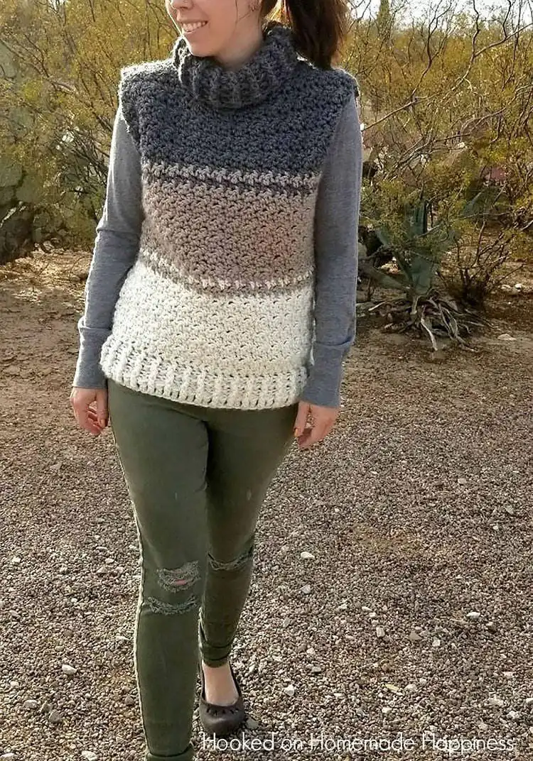An elegant Cowl Sweater Vest with a draped neckline, shown layered over a long-sleeved shirt.