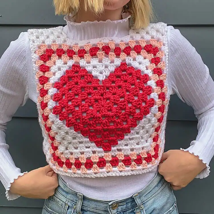 A charming Heart Granny Square Vest featuring heart designs within each granny square, in vintage tones.