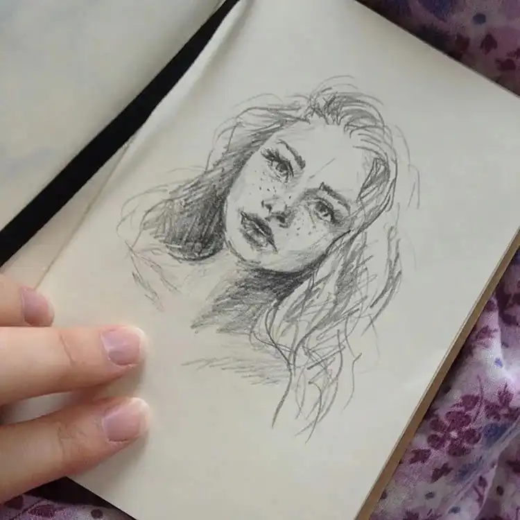 Quick pencil sketch of a girl with freckles, emphasizing youthful character design.