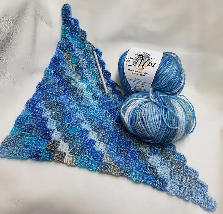 A cozy Be a Deer C2C Afghan featuring a charming deer motif in blue tones.