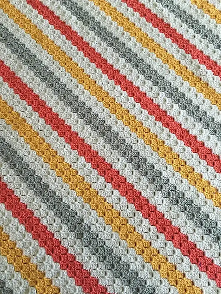 A textured Corner to Corner Crochet Throw, ideal for cozy evenings.