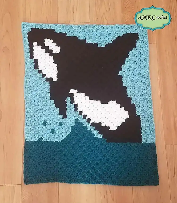 A vibrant Tropical Leaves C2C Blanket featuring lush green leaf patterns.