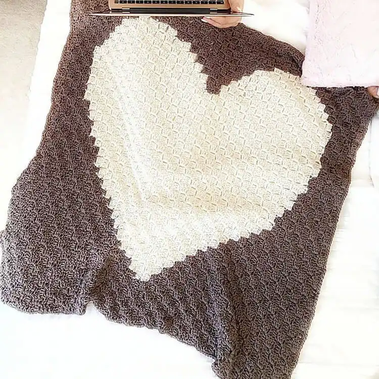 A colorful Corner-to-Corner Baby Blanket made with variegated yarn, perfect for gifting.