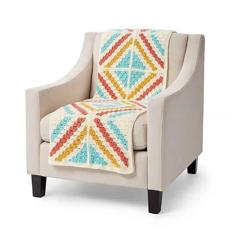 A creative C2C Bookcase Blanket showcasing shelves filled with colorful crocheted books.