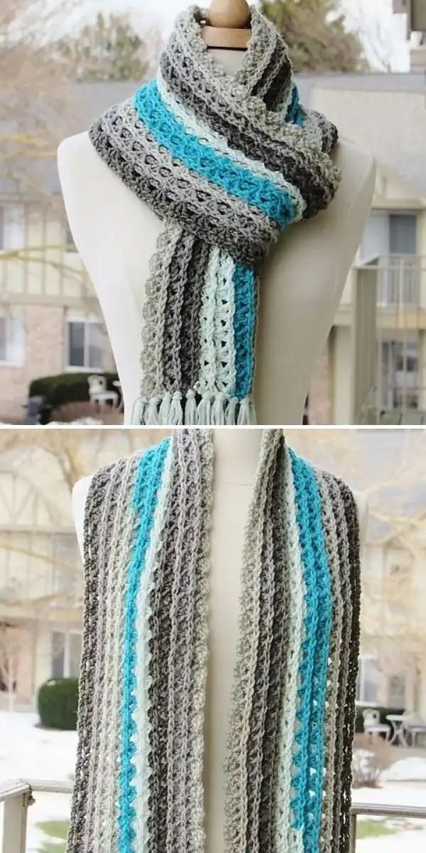 A lacy crochet scarf with long stripes in shades of blue and green, evoking ocean waves, for the Ocean Waves Scarf pattern.