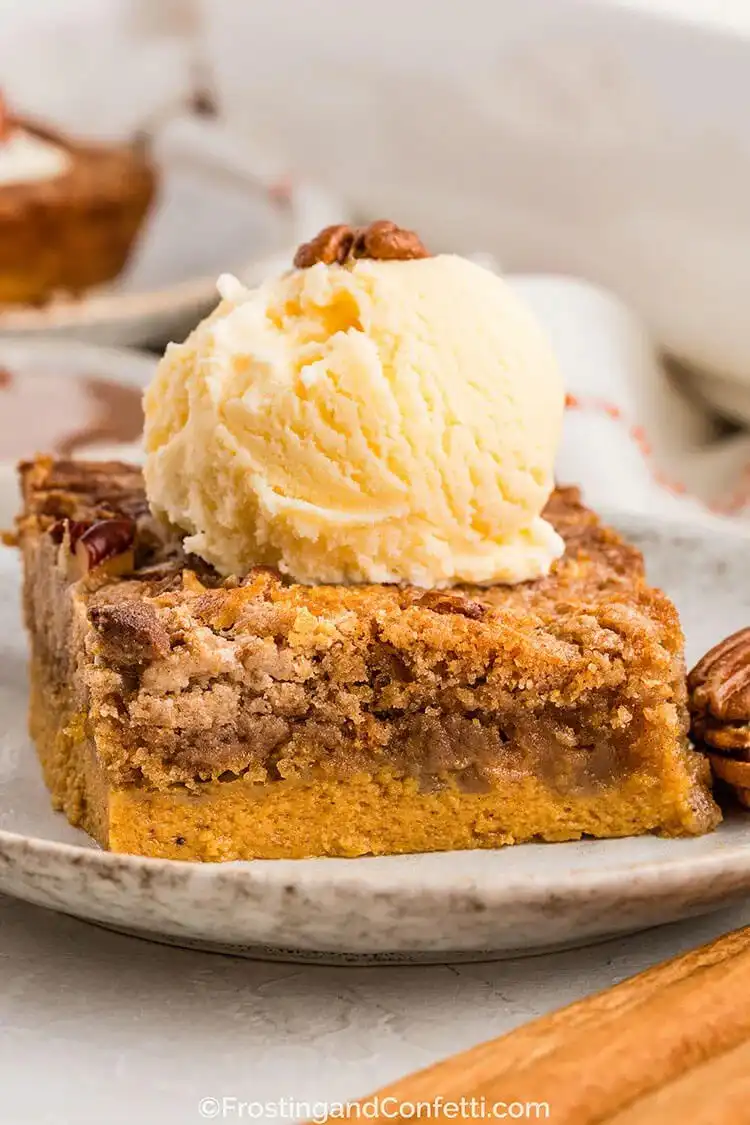 A warm pumpkin dump cake with a buttery spiced topping and pecans, perfect for fall.
