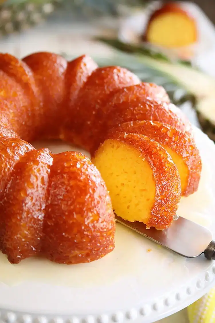 A slice of pineapple juice cake, highlighting its moist, tropical texture.