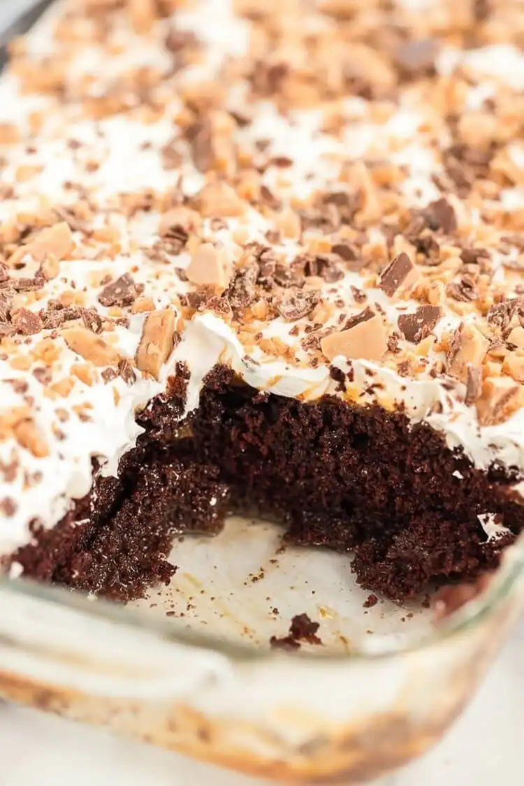 A decadent better than anything cake with chocolate, caramel, whipped cream, and toffee.