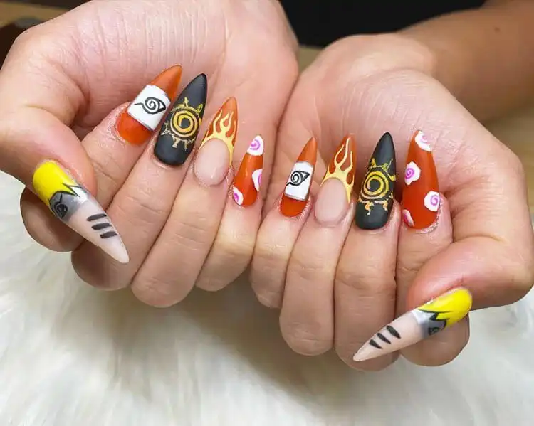 23 Anime Nail Designs to Show Your Love for Anime and Manga - Jujutsu Kaisen Sukuna 6 Stiletto acrylic Naruto nails featuring bold Akatsuki clouds and Konoha village symbols.
