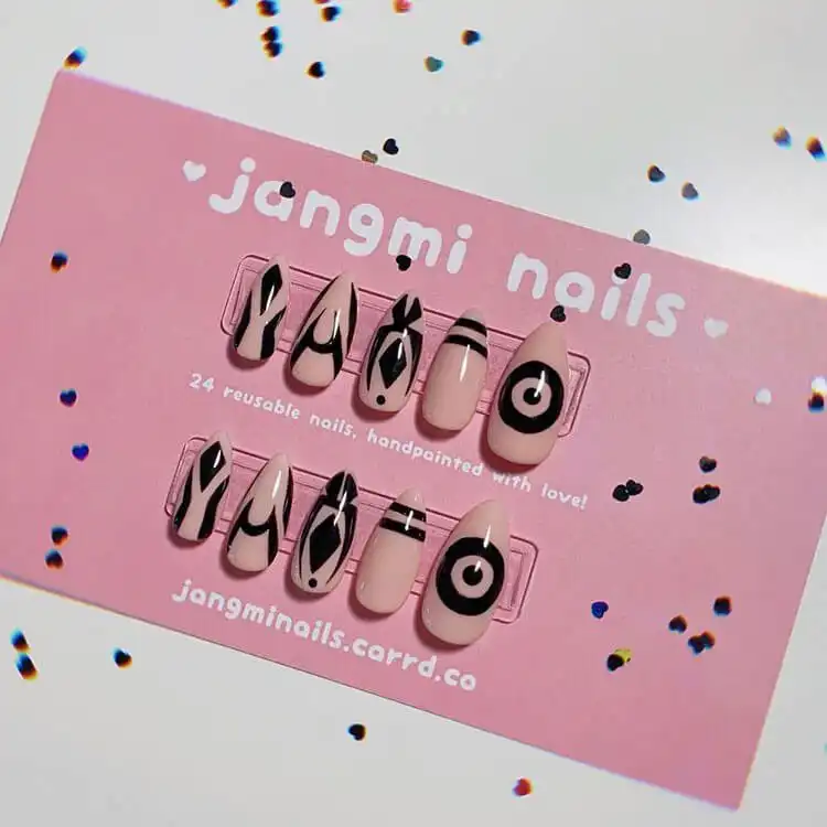 23 Anime Nail Designs to Show Your Love for Anime and Manga - Jujutsu Kaisen Sukuna 7 Jujutsu Kaisen Sukuna inspired nails with intricate facial markings and cursed energy patterns in dark hues.