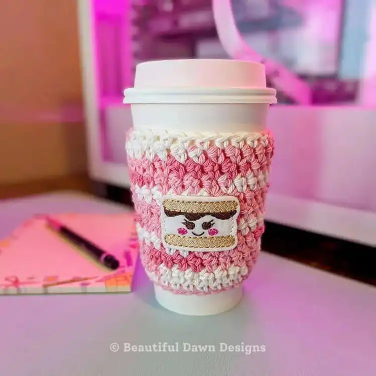 A quick 20-minute crochet cup cozy with a small leaf applique, holding a coffee cup