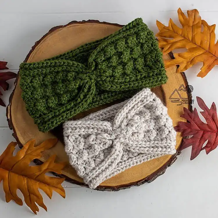A small amigurumi pumpkin pie with a whipped cream top and cinnamon stick