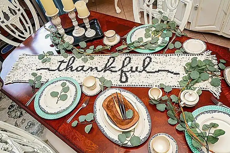 A long crochet table runner with the word 'Thankful' incorporated into its design, for Thanksgiving