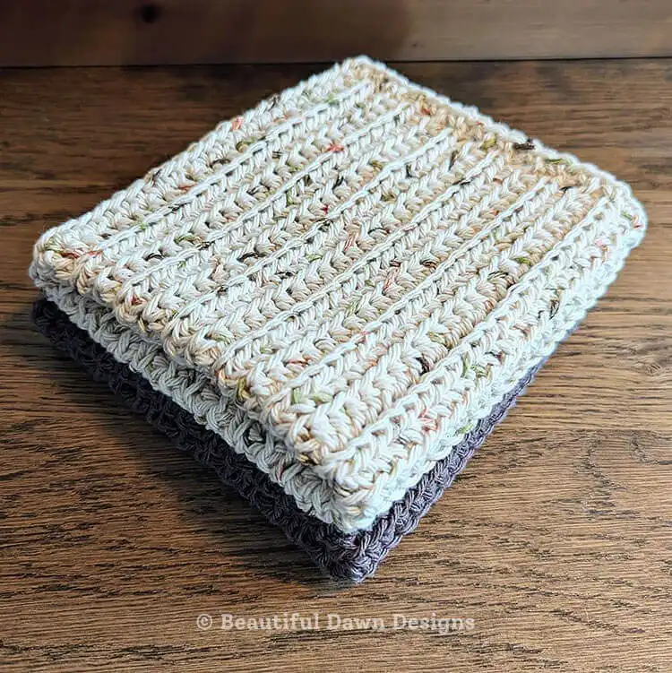 A large, textured crochet dishcloth in fall colors, showcasing a Fall Harvest theme