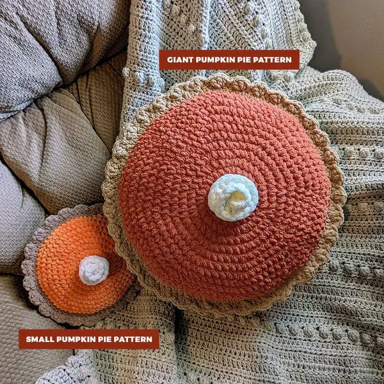 A large, round crochet pillow resembling a whole pumpkin pie, with a crust and filling