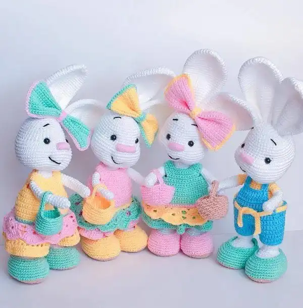 A crocheted bunny wearing an intricate kimono, inspired by sakura blossoms.