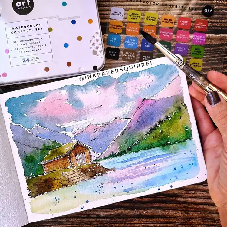 Watercolor painting of a house by the lake with mountains and colorful landscape