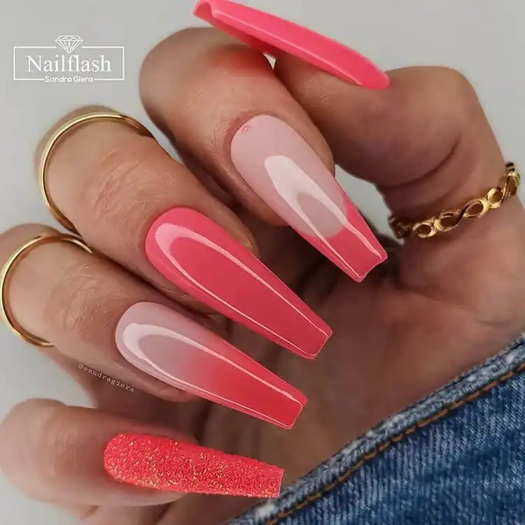 Long pink coffin-shaped acrylic nails, showcasing a glamorous and sophisticated aesthetic.