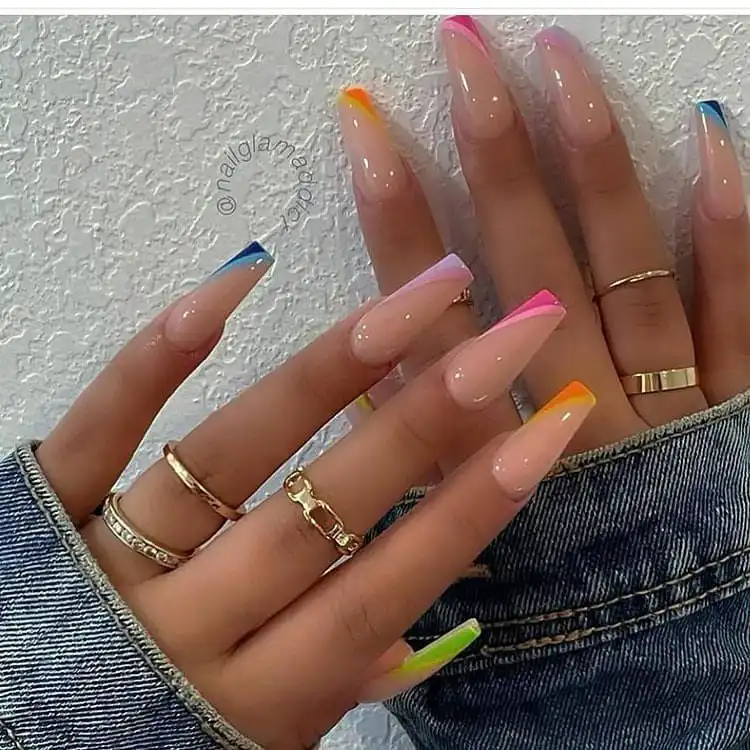 Colorful acrylic nails with vibrant hues strategically placed on the tips, creating a trendy and unique effect.