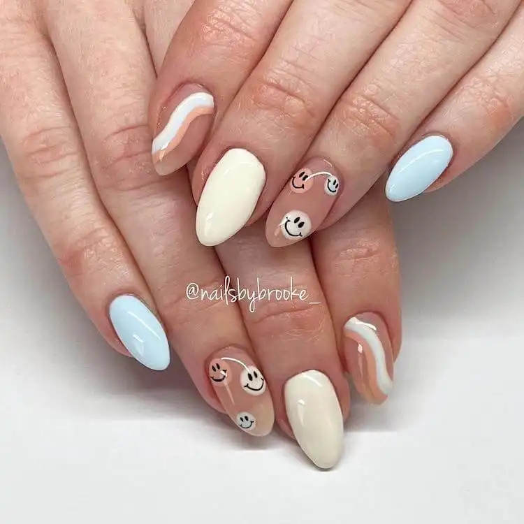 Neutral-toned acrylic nails featuring subtle smiley faces, offering a chic and minimalist summer design.