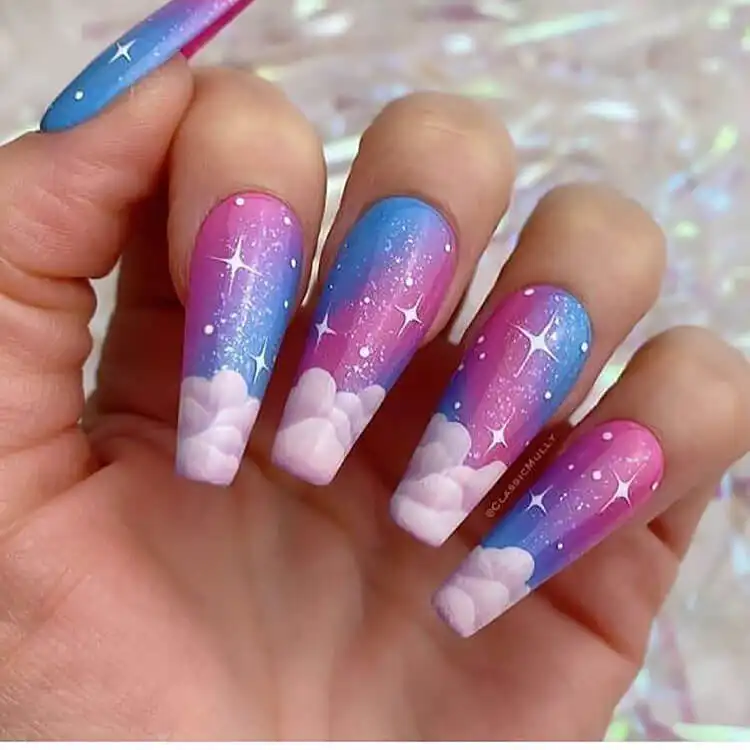 Dreamy clouds and stars acrylic nail art against a blue and pink gradient sky, evoking a magical ambiance.