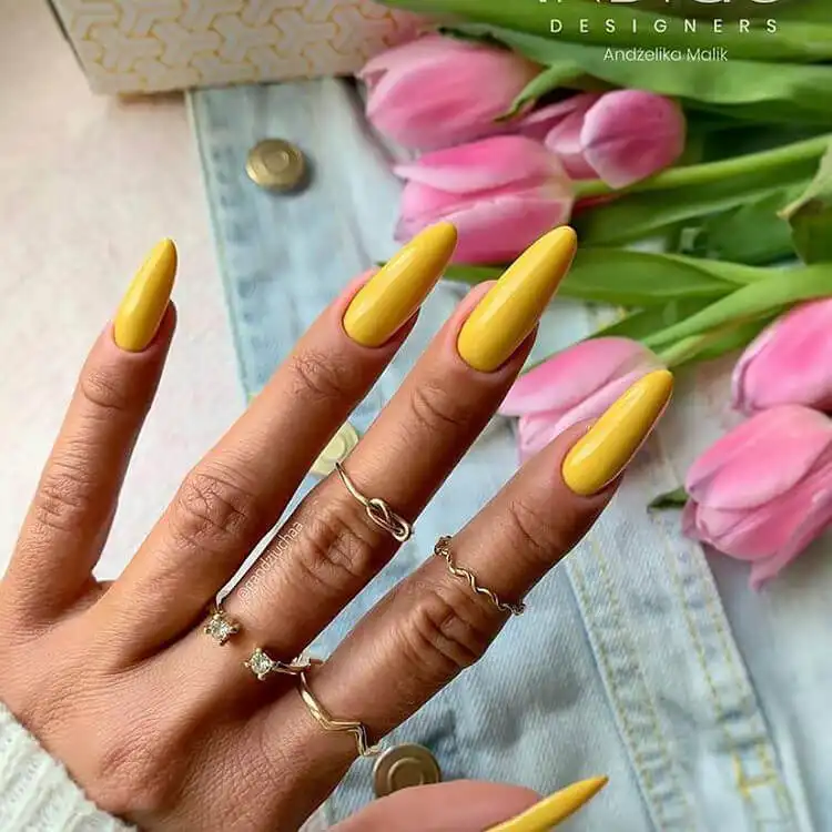 Long solid yellow acrylic nails, a vibrant and cheerful choice for a simple yet striking seasonal look.