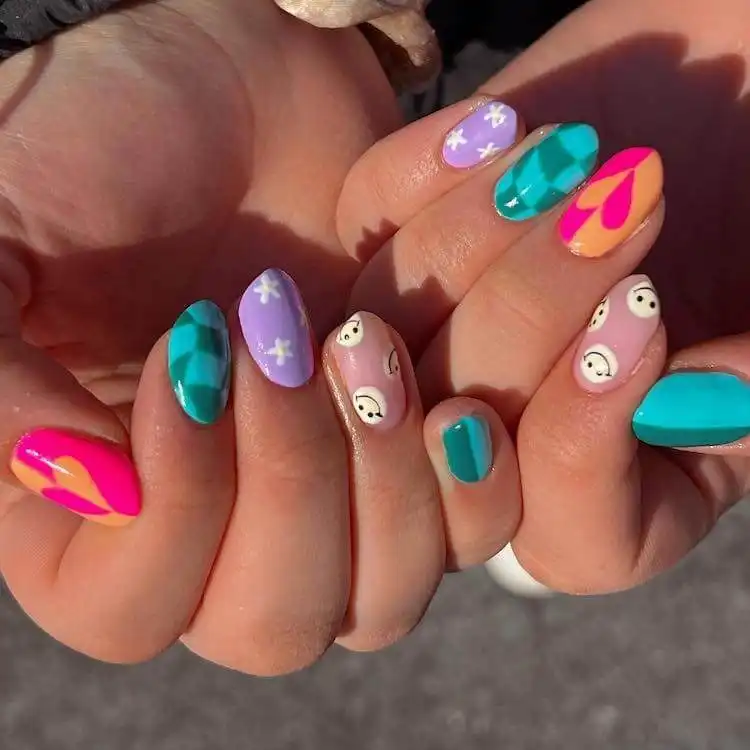 Fun patterned acrylic nails featuring various designs like abstract shapes and color blocks, expressing individuality.