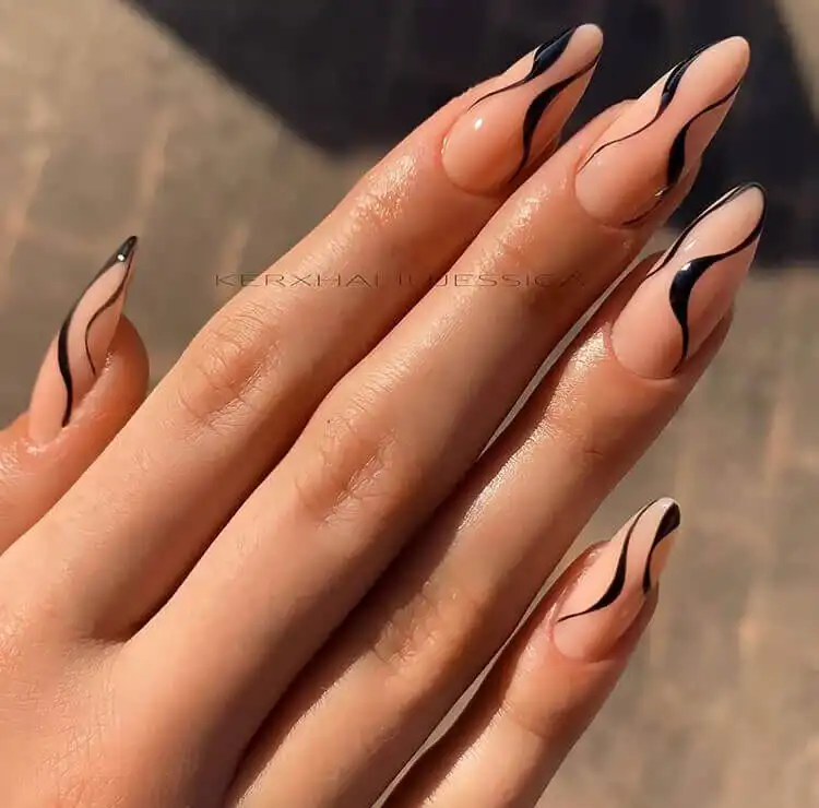 Sophisticated black swirl acrylic nails over a light base, creating an artistic and elegant visual appeal.