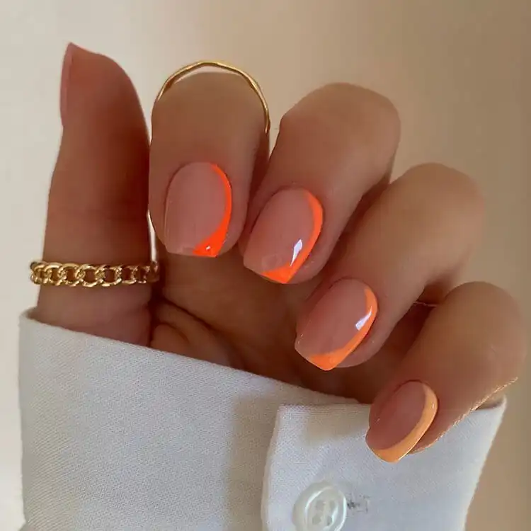 Vibrant short neon orange acrylic nails, perfect for adding a bright and energetic pop of color for summer.