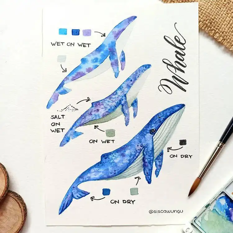 Watercolor illustration of a majestic whale swimming in blue ocean waters.