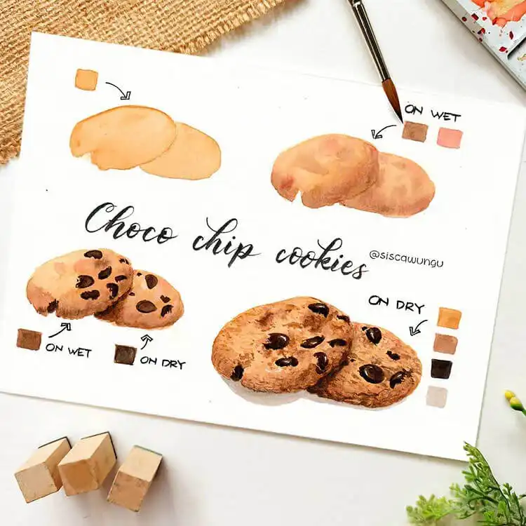 Watercolor painting of chocolate chip cookies with detailed textures and melted chocolate.