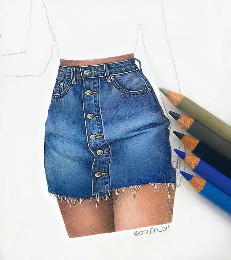 Denim skirt with a fringed hem, illustrating textured edges and fabric flow