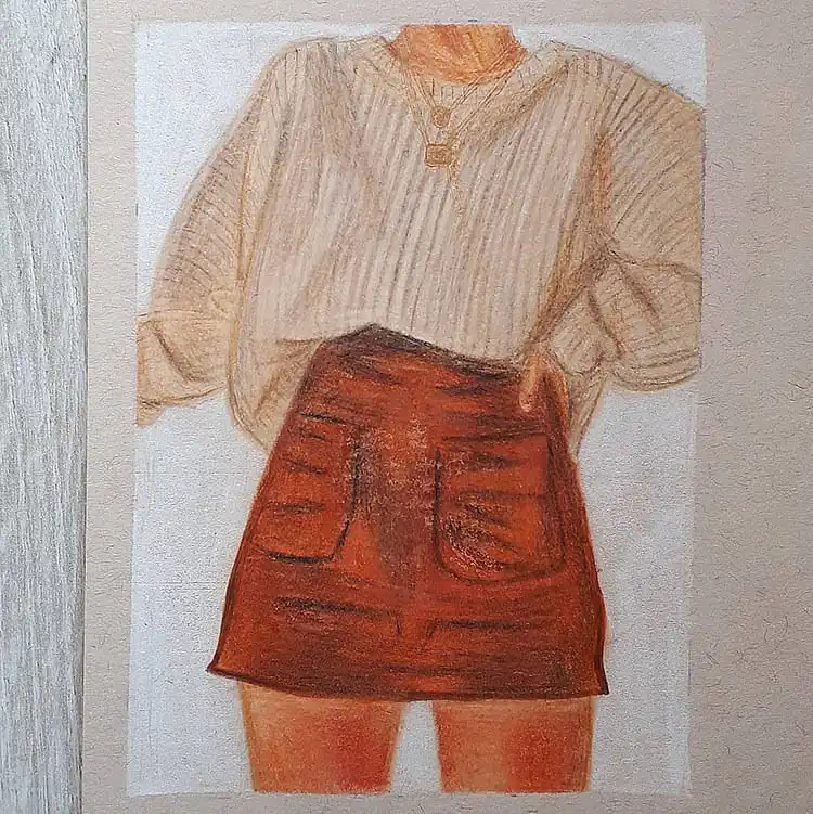 Brown sweater with a red skirt and a prominent necklace, highlighting jewelry details