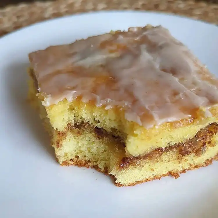 Close-up of a Maple Pecan Honey Bun Cake, showing the maple glaze and pecan filling.