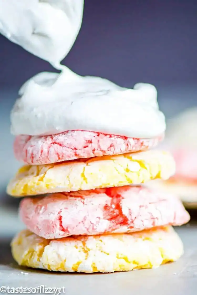 A stack of light and fluffy Cool Whip Cookies, dusted with powdered sugar.
