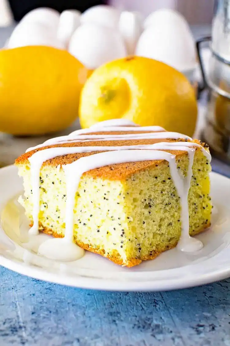 A beautifully sliced Lemon Poppy Seed Cake, showing its moist texture and poppy seeds.