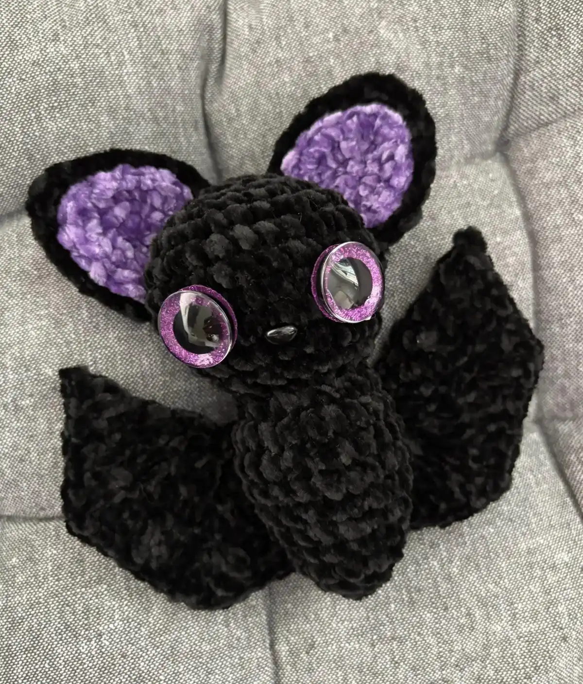 Close-up of a charming small amigurumi bat with large ears and friendly eyes, ready for Halloween.