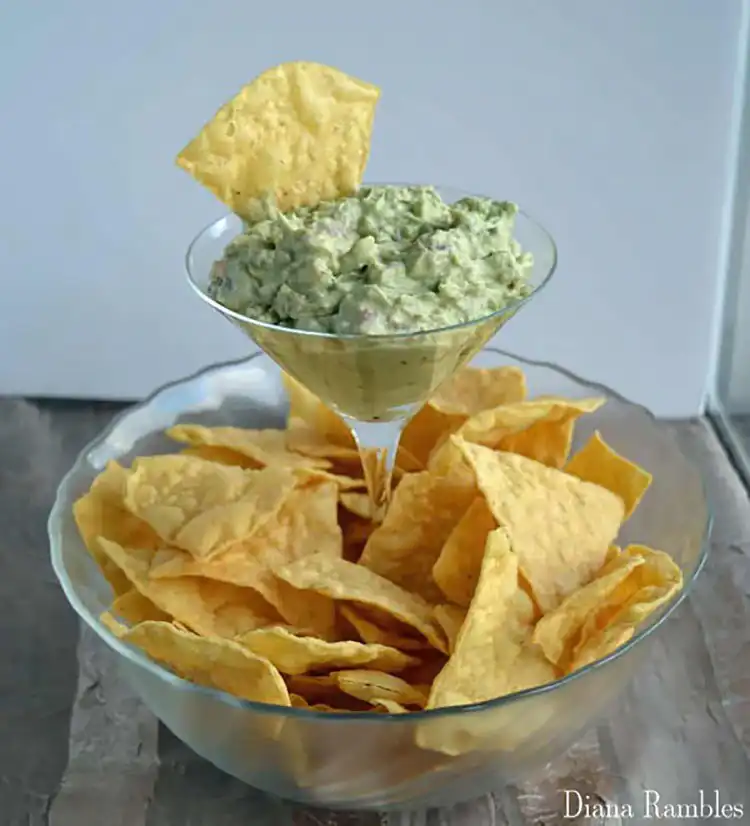 An elevated chip and dip bowl made by attaching a smaller dip bowl to a larger chip platter, both from the dollar store.