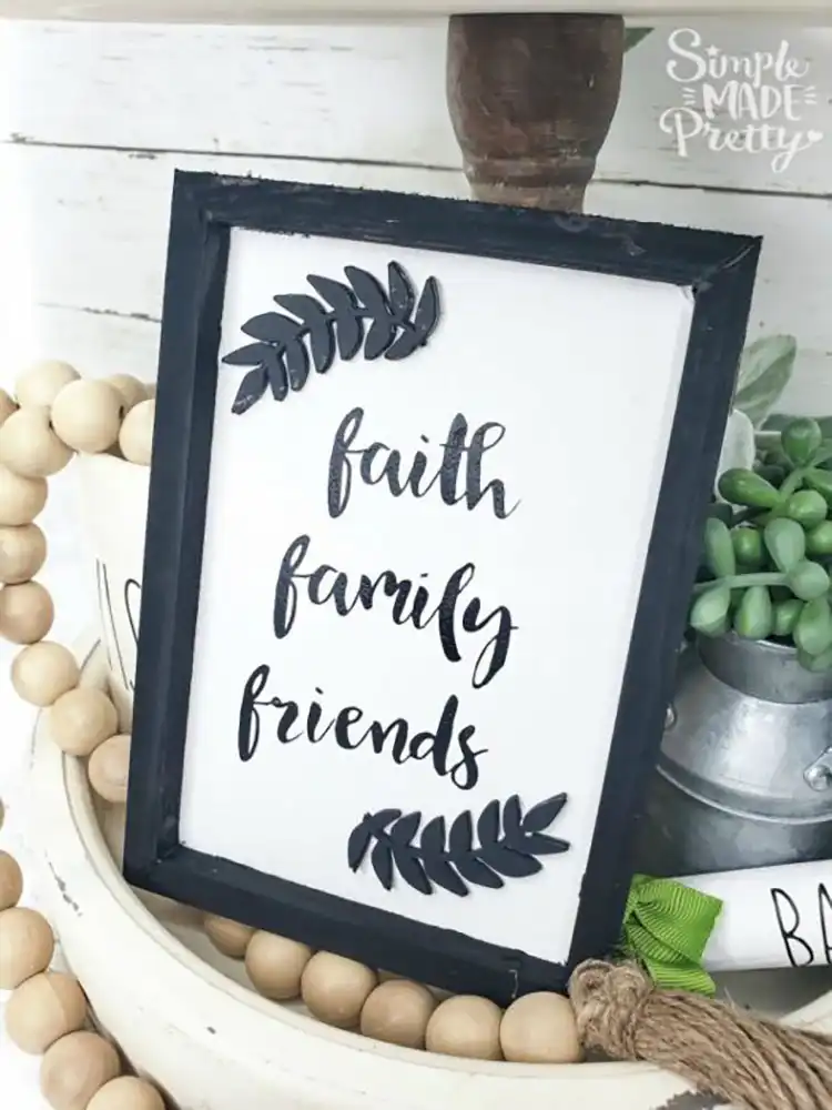 A farmhouse-style sign created using the reverse canvas technique with a dollar store canvas, featuring a welcoming quote.