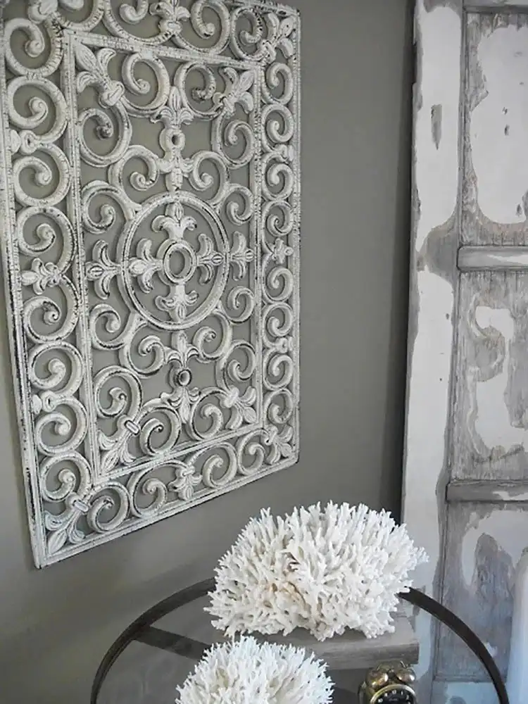 A piece of textured wall art created from a spray-painted dollar store rubber doormat, displaying an intricate pattern.