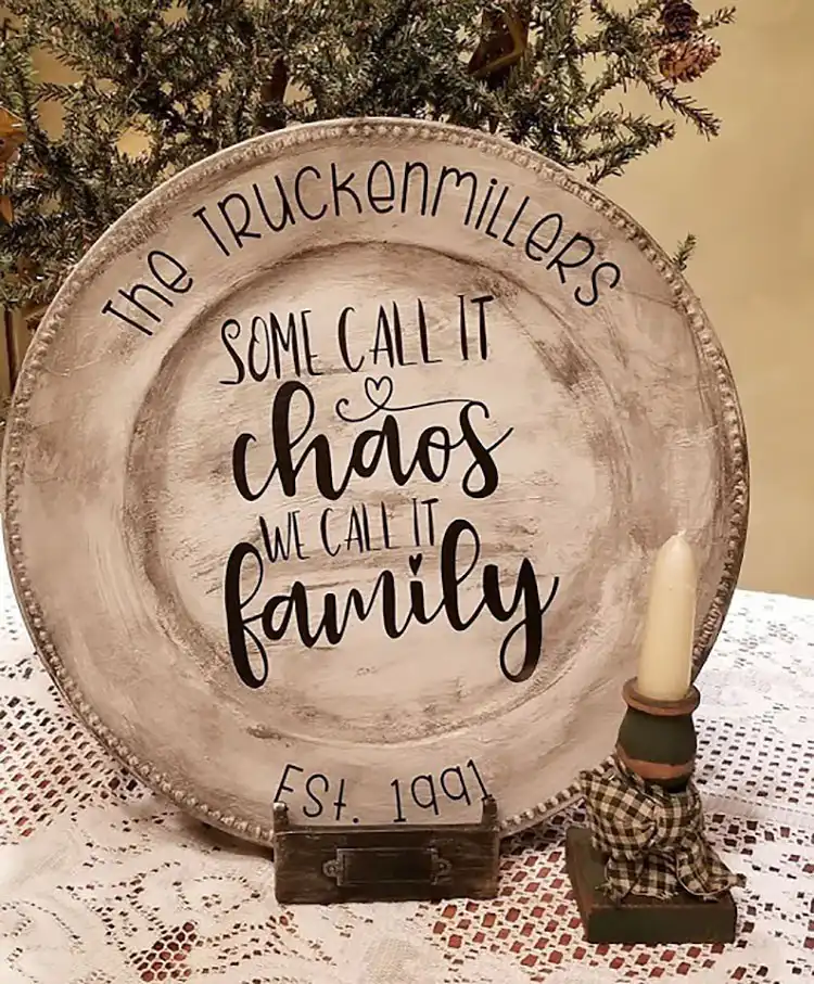 A set of plain dollar store charger plates customized with decorative painting and stenciled designs for a personalized table setting.