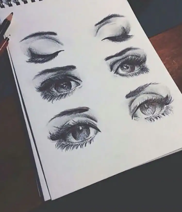 Three distinct sets of eyes drawn with different expressions and angles, including closed eyes.