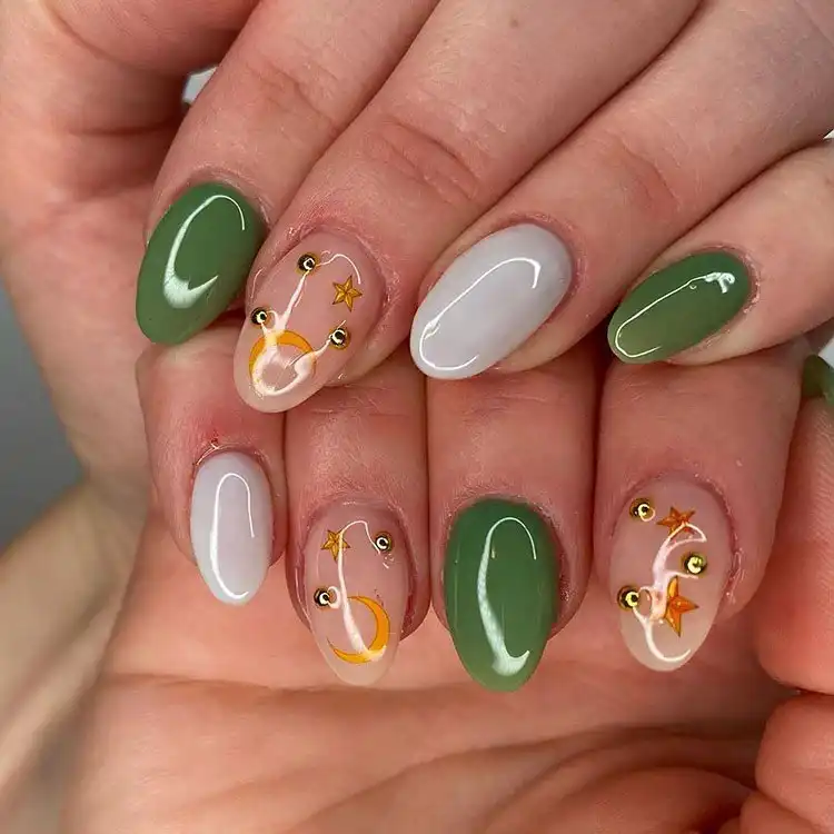 Acrylic Fall Coffin Nails with Orange and Brown Polish with Glitter 11 Green and White Acrylic Coffin Nails with Moon and Star Designs, creating a magical celestial look for fall