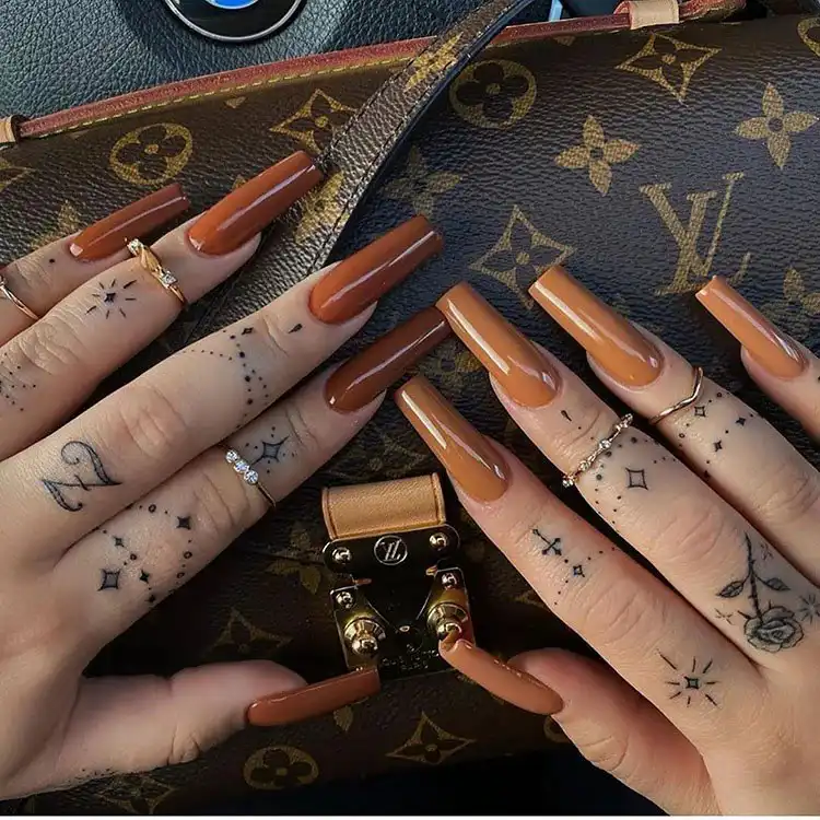 Acrylic Fall Coffin Nails with Orange and Brown Polish with Glitter 12 Two Shades of Brown Acrylic Coffin Nails, offering a chic and sophisticated autumnal color blend