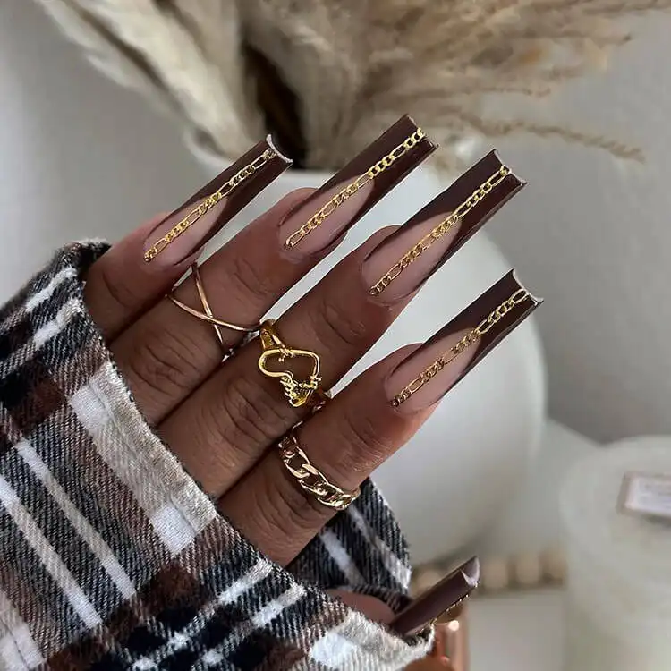 Acrylic Fall Coffin Nails with Orange and Brown Polish with Glitter 2 Brown French Tip Acrylic Coffin Nails with Gold Chain Embellishments, a daring and chic fall statement
