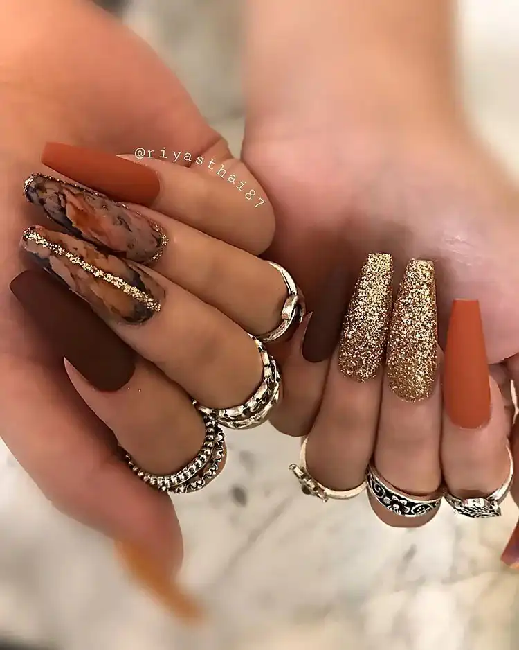 Acrylic Fall Coffin Nails with Orange and Brown Polish with Glitter 23 Leaves and Rhinestones on Long Orange and Brown Acrylic Coffin Nails, an opulent fall-themed manicure