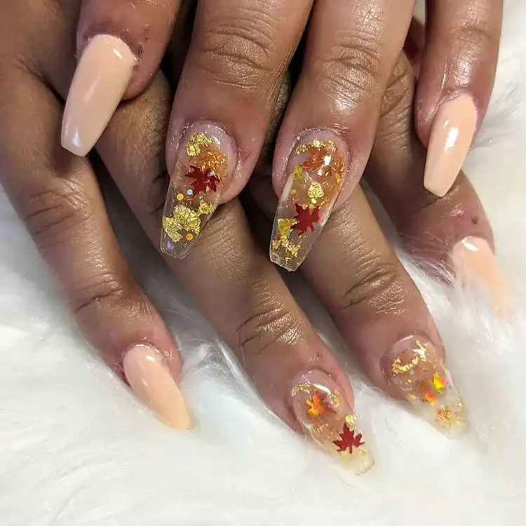 Acrylic Fall Coffin Nails with Orange and Brown Polish with Glitter 10 Clear Acrylic Coffin Nails with Embedded Fall Leaves and Gold Flakes, a whimsical and sparkling design