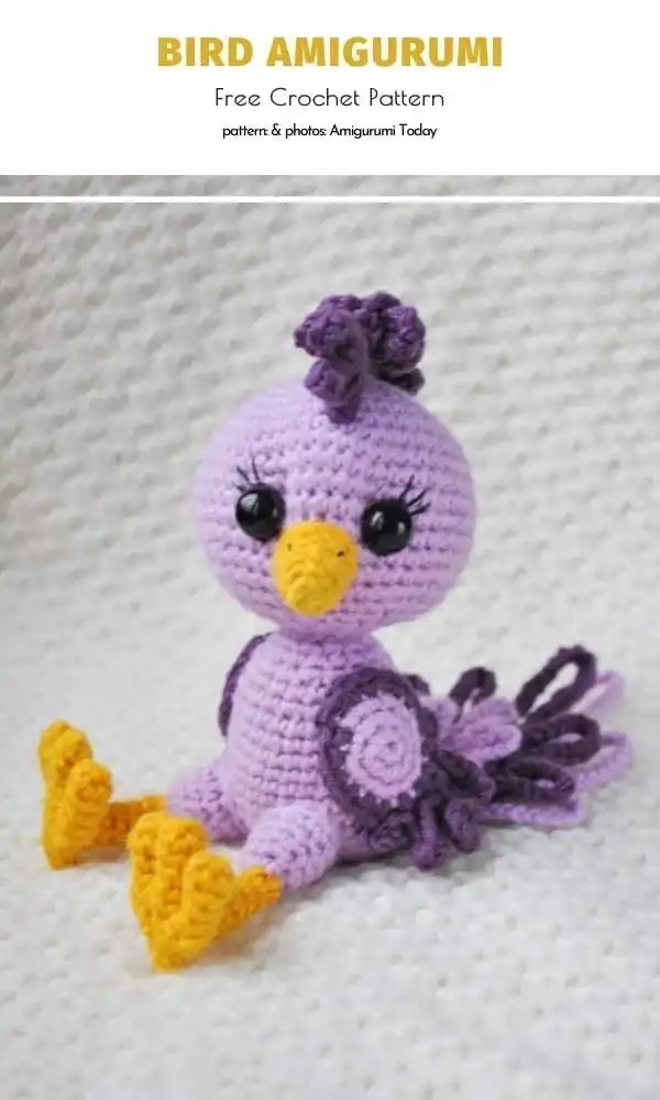 A cute, simple violet-colored amigurumi bird with a cheerful expression.